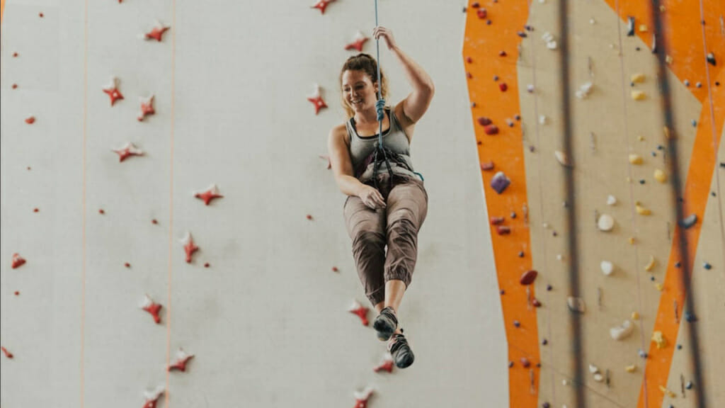Junge Frau beim Bouldern in der Kletterhalle