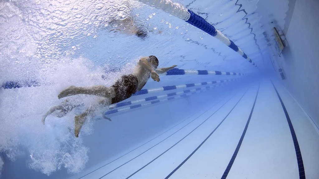 Fit durch Schwimmen - Unterwasser Aufnahme eines Schwimmers beim Kraulen